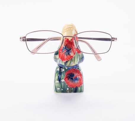flowers hand painted on this nos shaped glasses stand red and blue colours complement each other