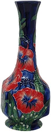small bud vase blue background and red flowers