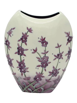 Flat and round purple vase cream background with lavender creeping up near to the rim attractive vase