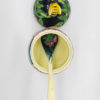 image is of the pottery honey pot looking down inside and seeing dipper spoon and bee on lid, garden colours and very pretty