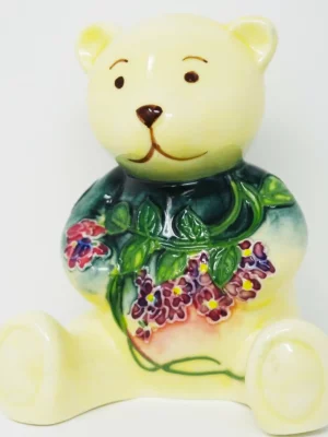 cream ceramic ornament of a bear with pink flowers